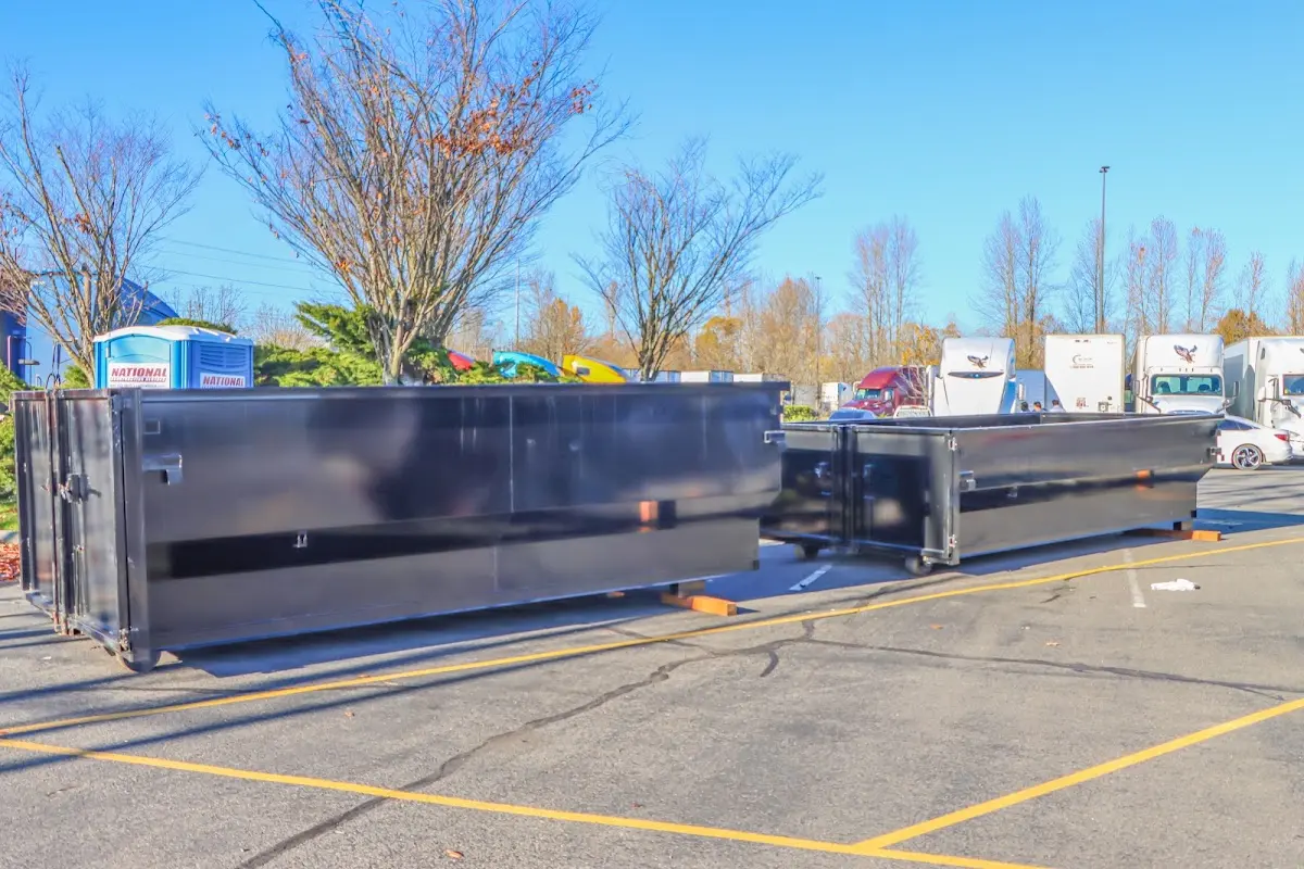 Professional dumpster rental service with roll-off container on residential driveway in Pinson